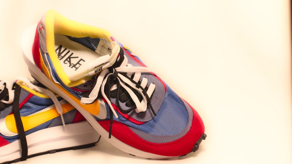 A pair of sneakers with a shoelace on top of them