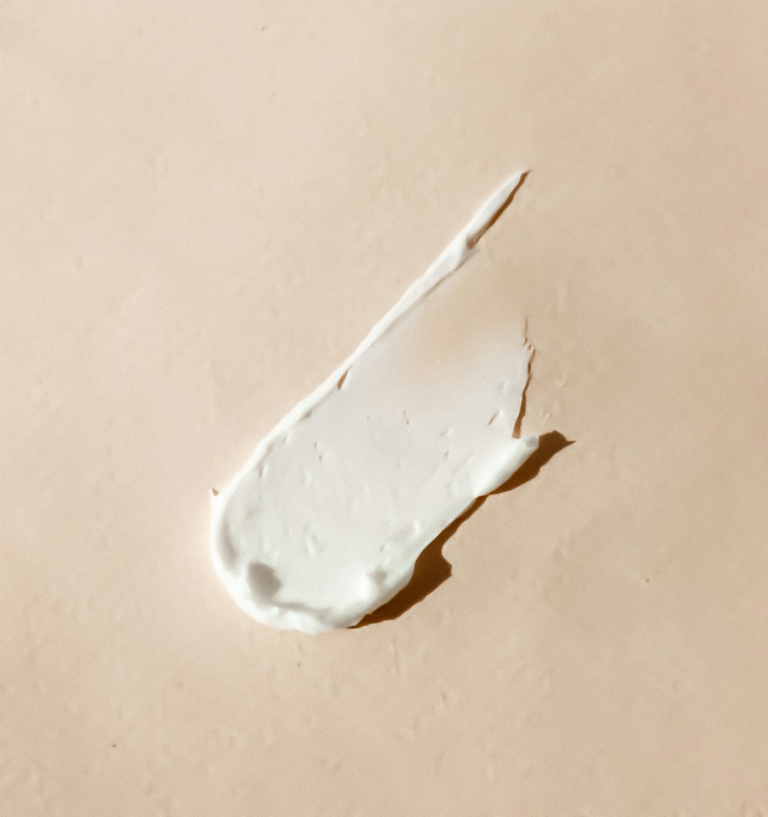 white cream smear on beige surface