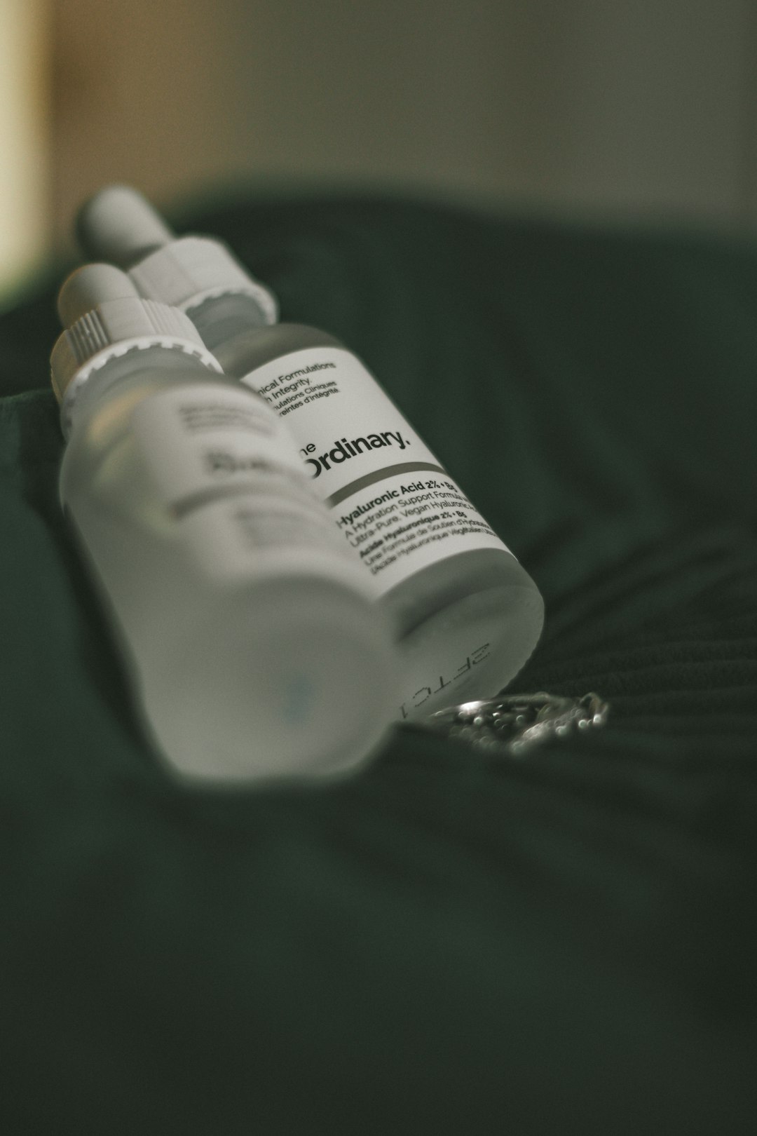 a close up of two bottles on a bed