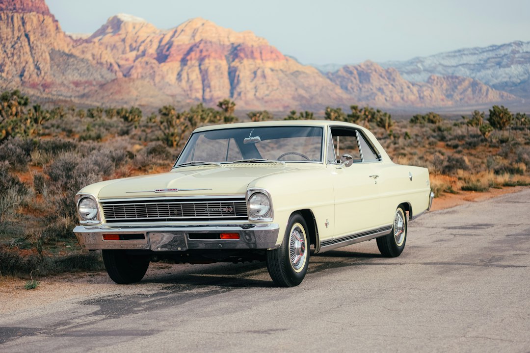 Vintage cream car parked on a desert road